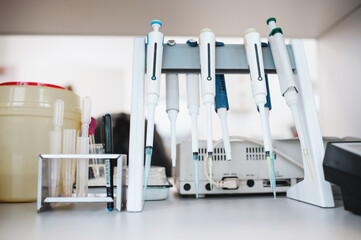 Set of dispensers in the laboratory on a stand. Automatic pipettes on the table in a modern medical...