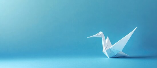 Origami crane representing healing and mental health support with blank space for text on calming blue background