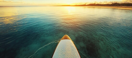 Golden Circle Stand Up Paddleboard on tranquil water at sunset with ample negative space for text and graphic overlay options