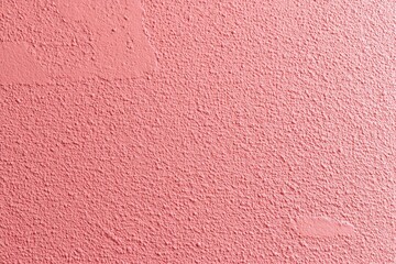 Textured Pink Wall Surface with Rough Plaster Design for Backgrounds or Creative Projects