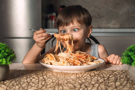 Cute little boy eating spaghetti. Funny life moments