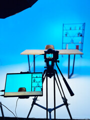 Podcast interview setup featuring a microphone and backdrop with a blue hue in a studio environment