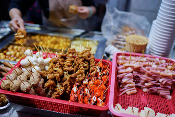 Assorted Grilled Skewers Displayed on a Vendor Stall During a Street Food Market