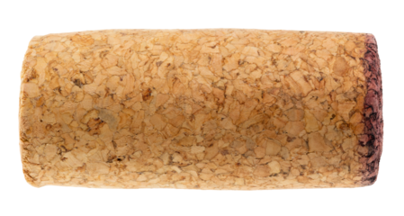 Detailed close-up of a used wine cork with textured surface and a red wine-stained edge isolated on a white background