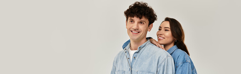 Captivating young duo showcases trendy fashion in a modern studio setting