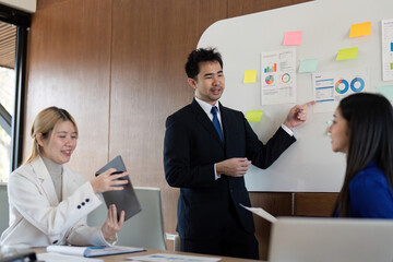 Diverse business team presenting financial analysis and insights in a modern office environment.