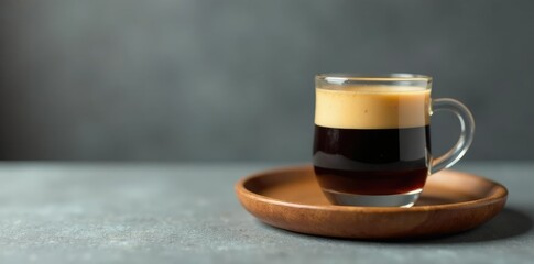 A wooden tray displays a glass of coffee with espresso on a gray background, coffee, liquid, wooden tray
