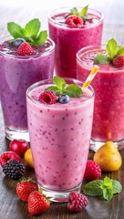 Vibrant berry smoothies in glasses with fresh fruit garnishes and mint leaves on a wooden table