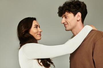 Young couple sharing a trendy moment in a modern studio setting filled with joy and love