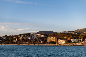 Fototapeta premium Coast Line near Malaga, Costa del Sol, Spain shoot from the boat during sunset. Beautiful Alboran Sea