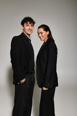 Stylish young couple showcases modern fashion in contemporary studio setting