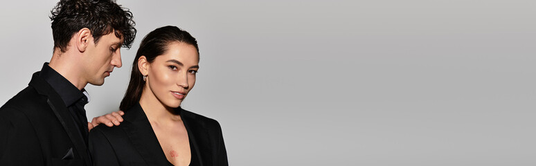 Stylish young adults showcasing contemporary fashion in an elegant setting