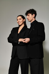 Stylish young couple posing elegantly in modern attire for a fashion shoot