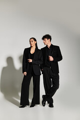 Stylish young couple exuding modern elegance in a minimalist setting