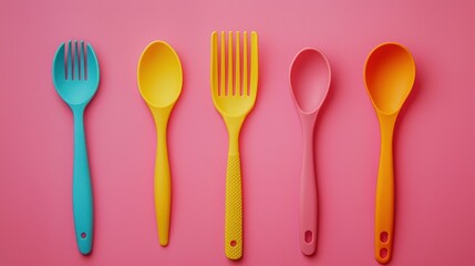 Colorful Plastic Utensils Arranged on Pink Background