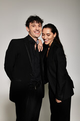 Stylish young couple sharing a joyful moment in modern fashion attire