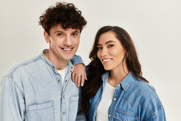 Stylish young couple embracing trendy fashion in a modern studio setting