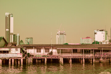 Infrered photography, A quaint wooden structure, seemingly a house or a small shop, stands on...