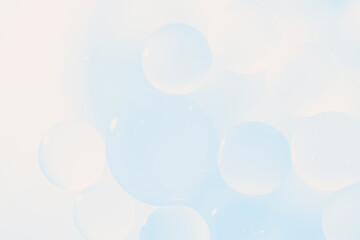 Delicate soft blue abstract background with numerous air bubbles floating in a soft gradient. Template for advertising cosmetic products, skincare branding