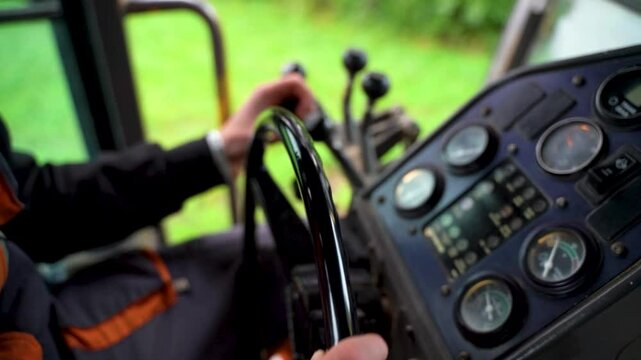 Inside View of Road Grader Operator Steering and Controlling Machinery at Road Construction Site