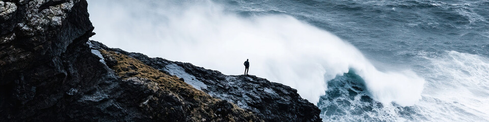 Person on Cliff Observing Ocean Wave
