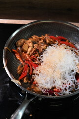 food view colorful food preparing in a pan, home cooking, paprika, chicken, onion, konjac pasta