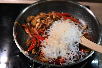 food view colorful food preparing in a pan, home cooking, paprika, chicken, onion, konjac pasta