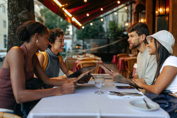 Tourists reading menu at restaurant in Rome