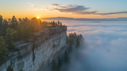 Fototapeta premium Sunrise over a foggy valley, seen from a clifftop.