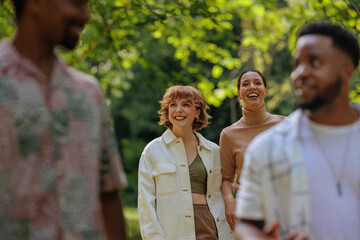 Two girls smiling as they walk through a park