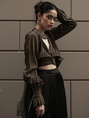 young beautiful woman standing on wall background