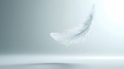 Fototapeta premium Ethereal white feather floats gently against a soft, muted grey background; minimalist, serene image evoking peace and tranquility.