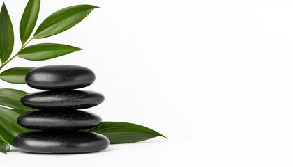 Fototapeta premium A calm arrangement of stacked black stones with green leaves, symbolizing balance and tranquility, perfect for wellness and relaxation themes.