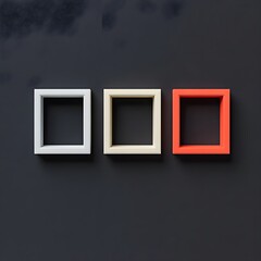 three empty photo frames hanging on the black wall