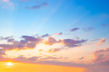 Blue sky with clouds illuminated by the setting sun. Beautiful skyscape