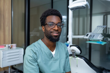 Fototapeta premium Handsome dentist at his workplace in modern clinic