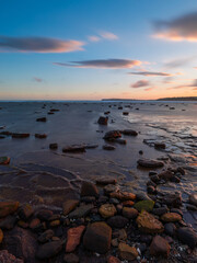 Fototapeta premium Long exposure view of rocky seascape at dusk.