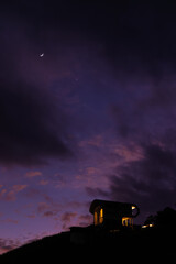 Crescent moon and star in the sky, resort on the hill, night scene shot