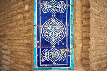Closeup view of old tiles on the walls of Ichan Kala heritage town