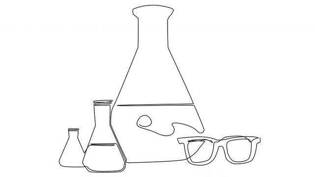 A high school lab setup features various glassware arranged alongside protective eyewear, ready for experiments in chemistry.