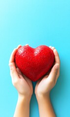 Hands holding red heart on blue background, health, love, care concept