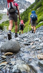 Hikers trekking on rocky stream in mountain valley