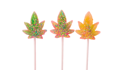 Cannabis leaf lollipops glittery, novelty treats, sweets, food styling, party favors, on white background, minimal design, modern, flat lay