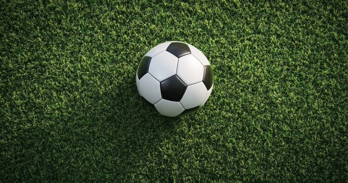 Soccer ball on green field, overhead view