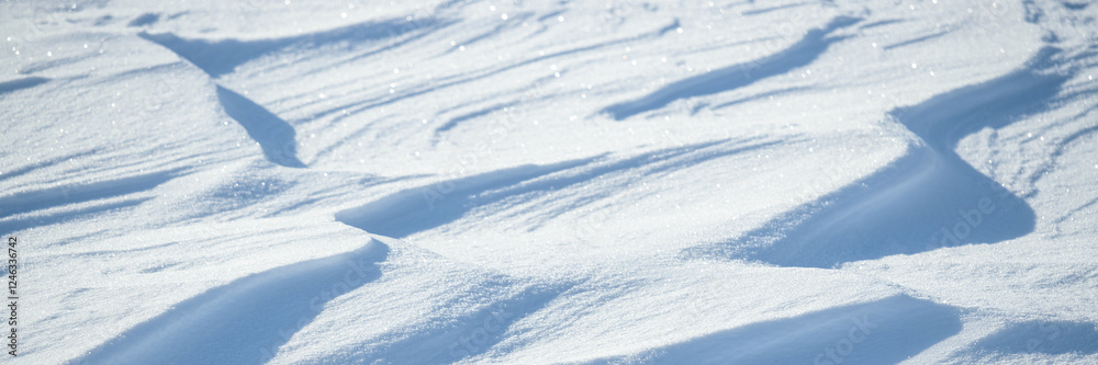 Wall mural snow texture. wind sculpted patterns on snow surface. wind in the tundra and in the mountains on the