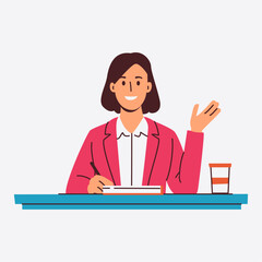 A smiling businesswoman sits at her desk taking notes and gesturing with her hand