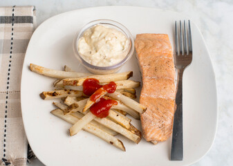 baked salmon  with french fries and tarter sauce