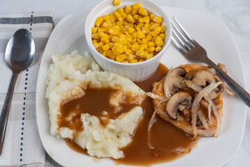 bneless pork chop  with mash potatoes and corn