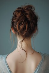 Elegant hairstyle on a woman with brown hair and soft waves captured indoors during natural light