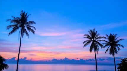 Fototapeta premium A Beautiful Sunset Over Calm Waters with Palm Trees Framing the Tropical Paradise